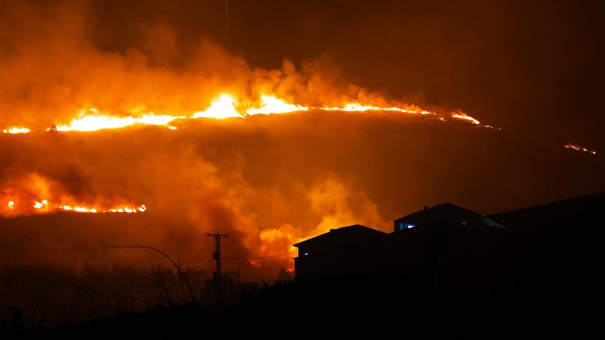 hillside on fire at night