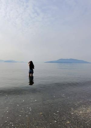 Person wading into water at beach