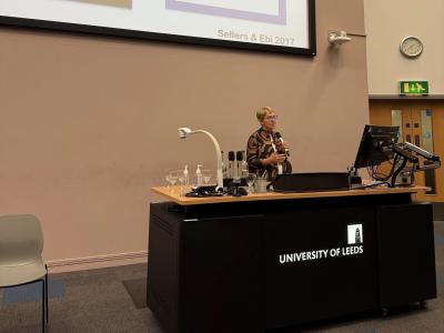 woman speaking at a desk