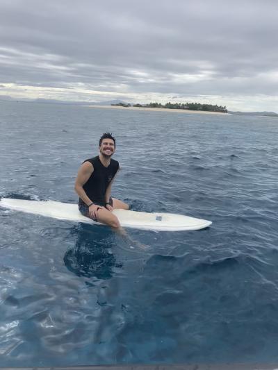 Man sitting on a surfboard in the ocean
